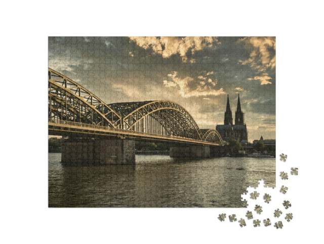 Puzzle 1000 pezzi „Cattedrale di Colonia al tramonto con il Reno, Renania Settentrionale-Vestfalia, Germania“