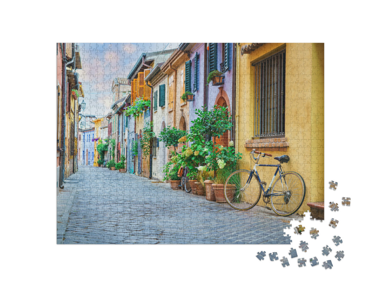 Puzzle 1000 pezzi „Strada del borgo marinaro di San Guiliano con case colorate e una bicicletta al mattino presto a Rimini“