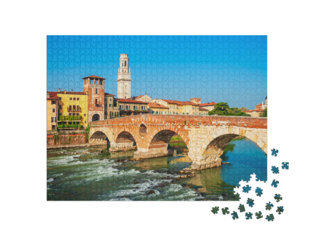 Puzzle 1000 pezzi „Ponte Pietra è un ponte romano ad arco in pietra che attraversa il fiume Adige a Verona, in Veneto.“