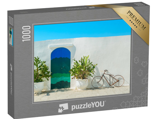 Puzzle 1000 pezzi „La porta blu con cactus e le tradizionali mura bianche della città di Ostuni (Puglia - Italia).“