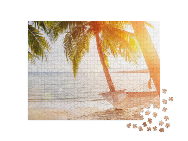 Puzzle 1000 pezzi „Amaca su una palma al tramonto“