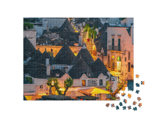 Puzzle 1000 pezzi „Trulli di Alberobello, Puglia, Italia. città di Alberobello con case a trulli tra piante verdi e fiori“