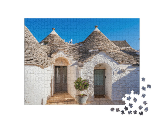 Puzzle 1000 pezzi „Famose case tradizionali in pietra a secco con tetti conici ad Alberobello, Italia.“
