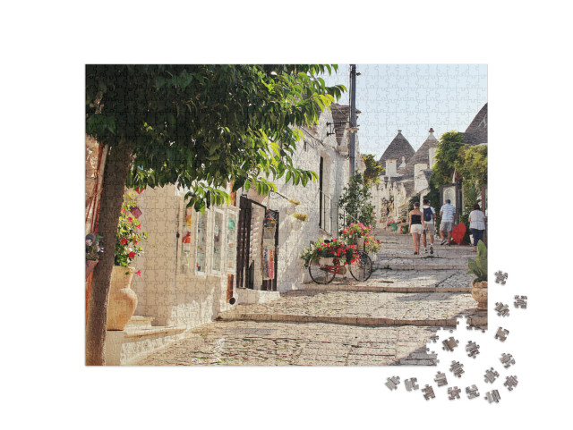 Puzzle 1000 pezzi „Alberobello con le sue stradine, le case bianche e gli edifici in pietra bianca“