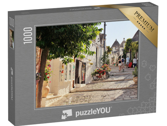 Puzzle 1000 pezzi „Alberobello con le sue stradine, le case bianche e gli edifici in pietra bianca“