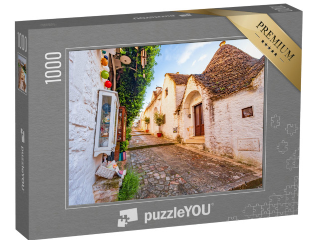 Puzzle 1000 pezzi „Trulli di Alberobello, Puglia, città di Alberobello con case a trulli tra piante verdi e fiori“