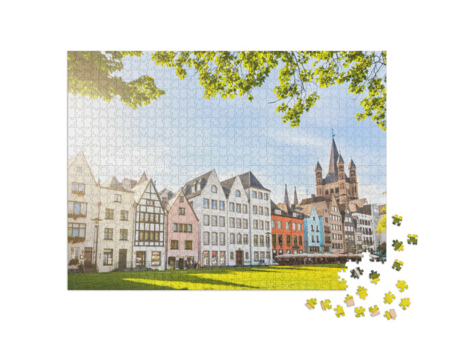 Puzzle 1000 pezzi „Case colorate e un parco verde a Colonia, Germania“